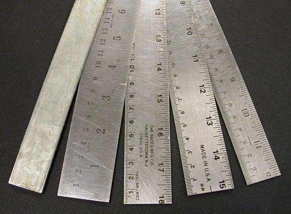 Rulers with metric and imperial measurements and a straight edge