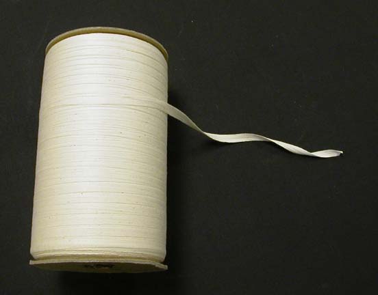 Woven cotton typing tape on a spool