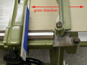 Using a template at the board shear to determine the size to cut the A tray floor
