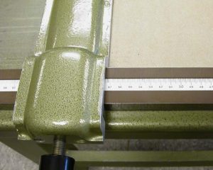 Cutting a piece of board for the front wall of the A tray on the board shear