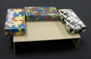 A tray inverted, with weights on the floor