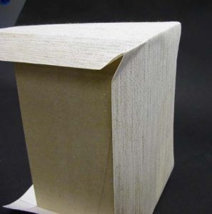 Cloth at bottom corners of A tray pinch in and ready to be trimmed