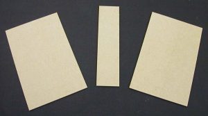 Pieces of binder's board cut for the box cover