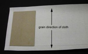 Cloth for box cover cut and showing grain direction