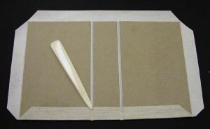 Gluing and turning in the turn ins, using a bone folder to smooth them down and make the creases at the joints
