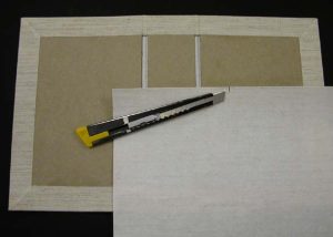 Cutting a piece of cloth to cover the inside spine area