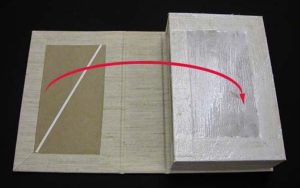 Bottom of B tray glued up with arrows showing how to flip the box over to put the B tray into position