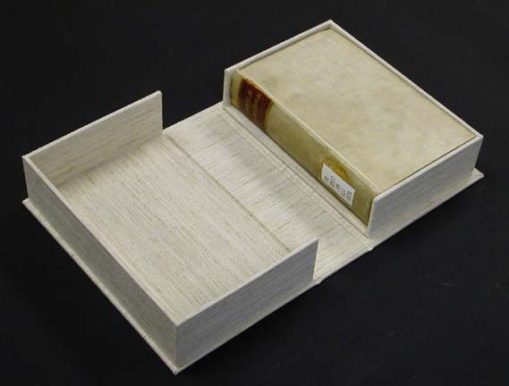 Cloth-covered clamshell box, open with book inside