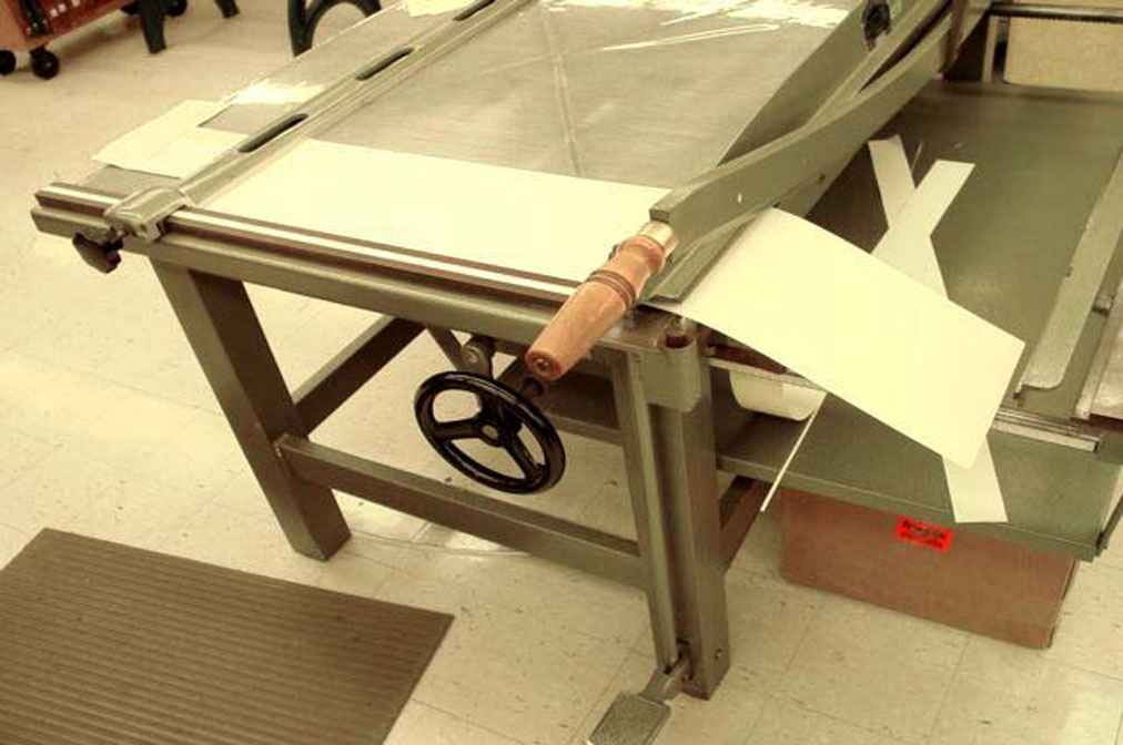 Making the 2nd cut of the folder stock for the Kyle Wrapper on the board shear to cut the piece to the length