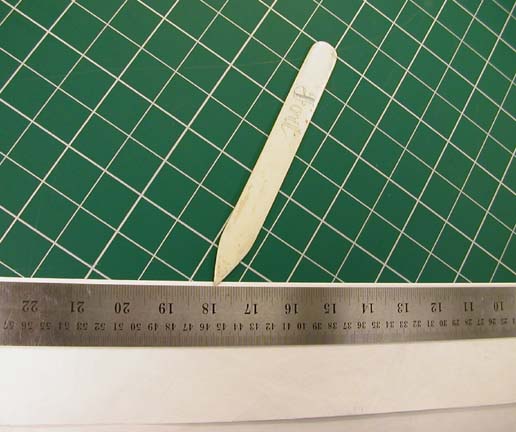 Making a hard crease with the bone folder after material is folded over