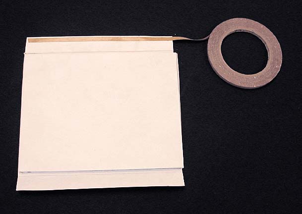 Applying double-sided tape to the two side flaps of the pocket