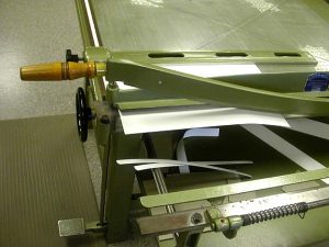Cutting the pieces of board on the board shear