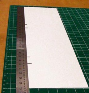 One strip of board with crease locations marked