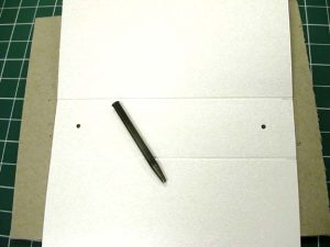 Board with two holes punched