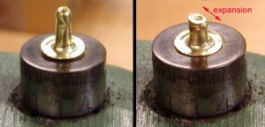 The two parts of the rivet positioned on the mandrel of the rivet bucker