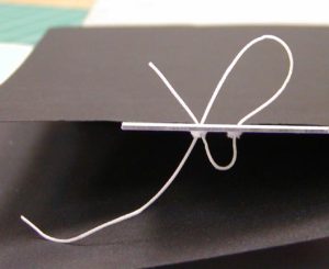 Threading the tie through the holes