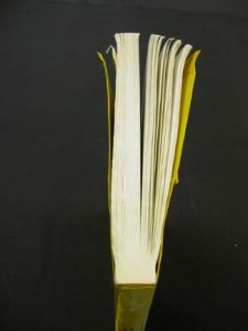 Adhesive bound book in need of rebinding, view from top