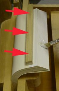 Glue is applied as the text pages are fanned right