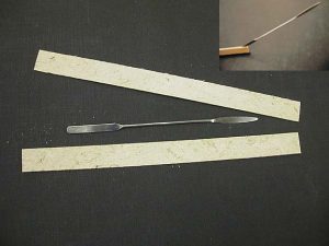 Delaminating the spine stiffener to make it thinner