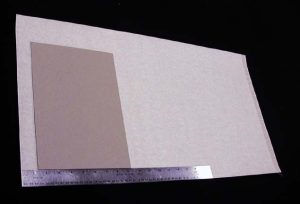 Cloth piece has been cut for the new case, and first board is positioned