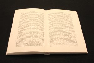 Adhesive bound book, open