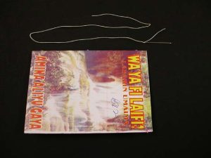 A length of thread next to the pamphlet