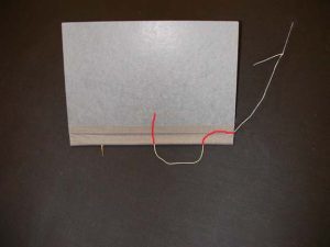 Needle goes from center hole outside to bottom hole outside