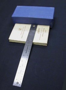 Measuring the width of the book with a ruler and block