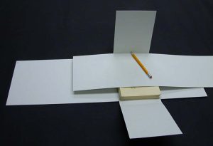 Placing a piece of scrap paper over the book to avoid pencil marks