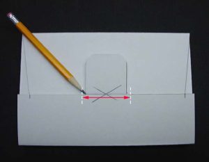 Box is folded closed and slot for tab is marked