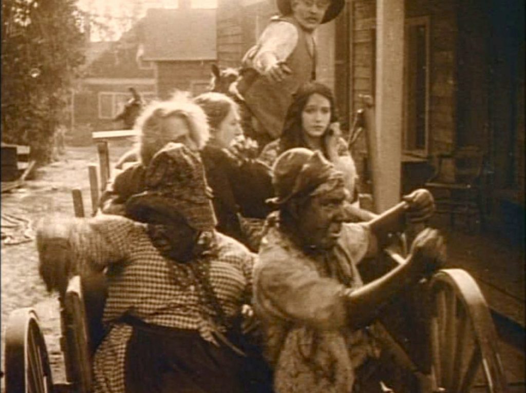 Griffith’s “faithful souls” helping their masters escape a black uprising (screen capture by author).