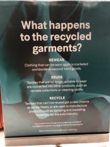 The sign for the H&M Garment Collection Program, describing how clothes are reworn, reused, or recycled