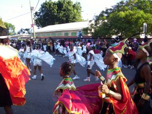 Children in a carnival procession in St. Kitts, West Indies, dressed in colorful costumes