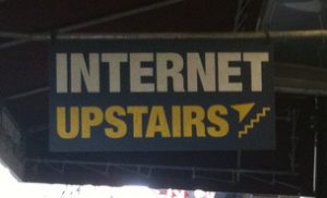 A sign that says "Internet Upstairs."