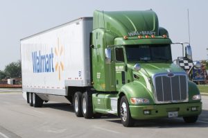 A semi truck with a large Walmart logo.