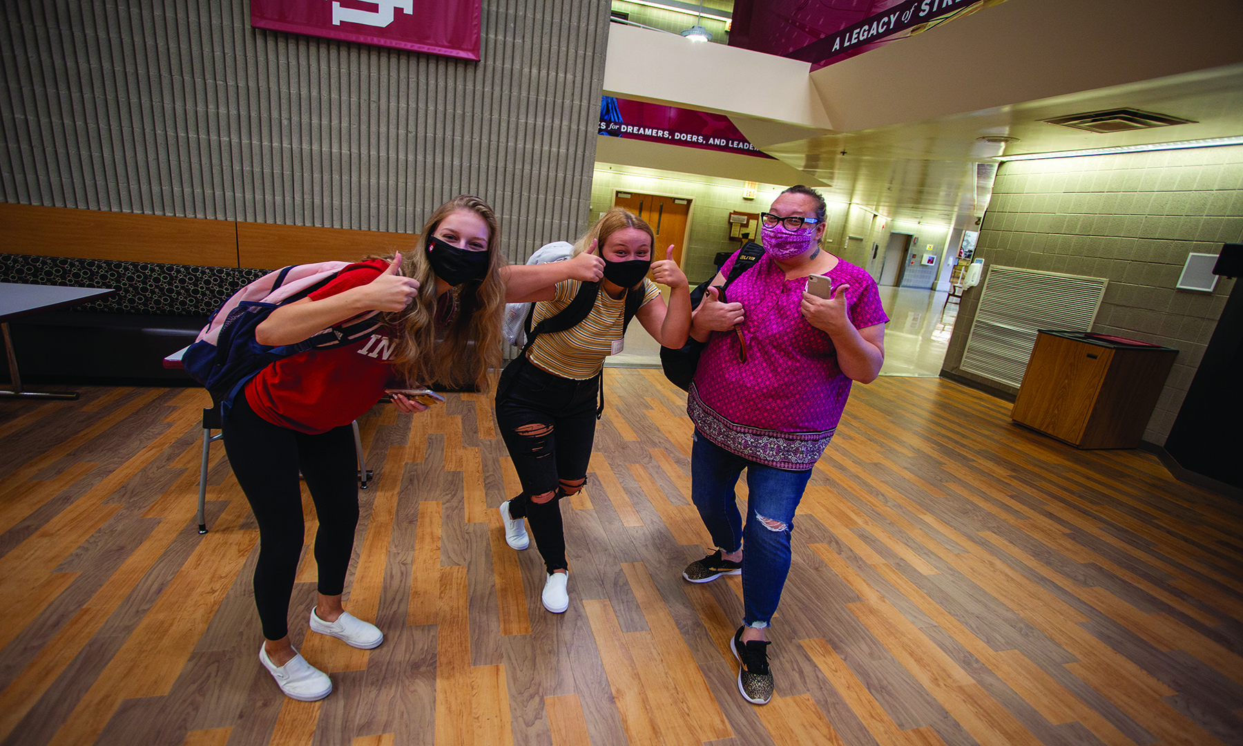 three smiling female students