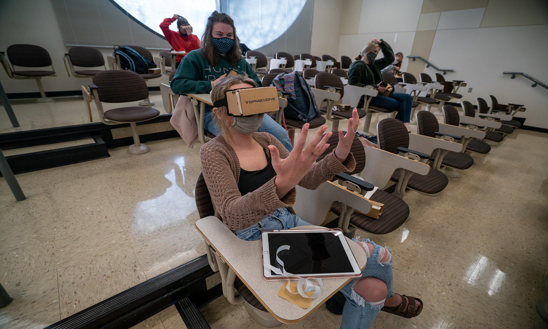 classroom with girl wearing virtual reality goggles