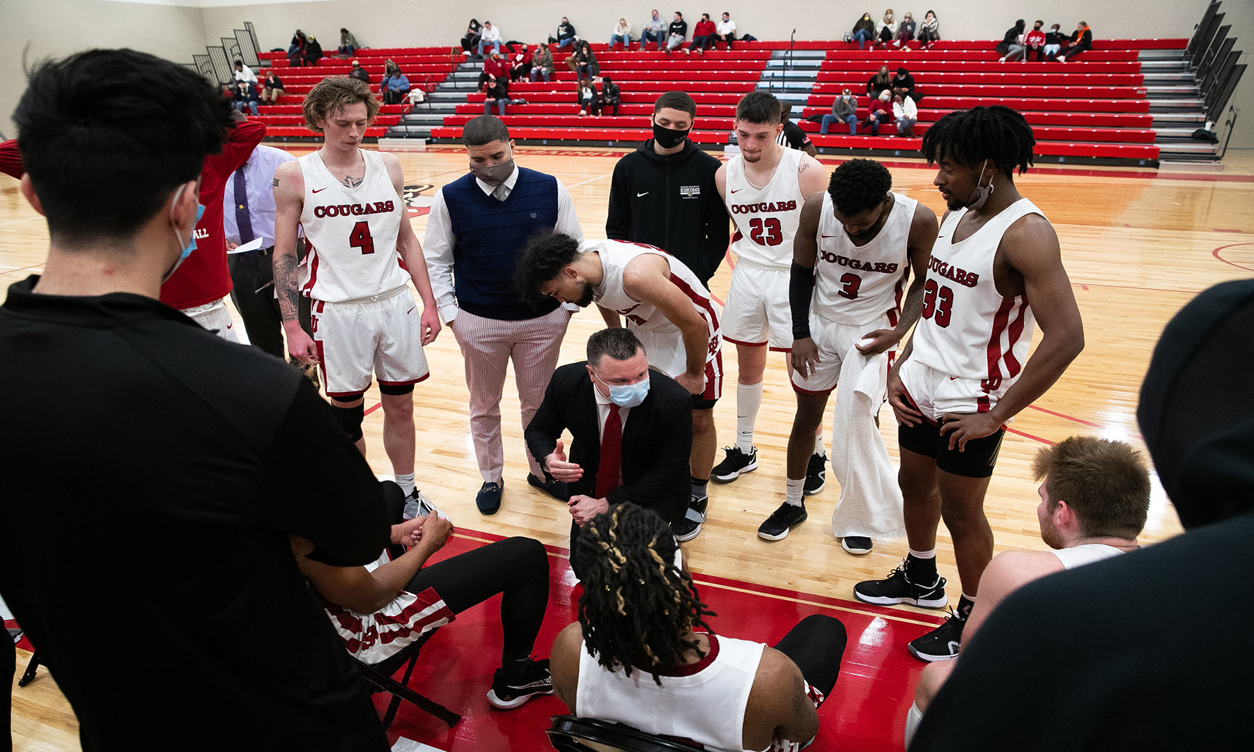 men's basketball team huddle