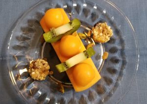 canteloupe cut in shapes on a plate with granola