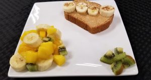 Whole wheat toast with cashew butter, banana, and cinnamon plus a side of fruit (banana, mango, and kiwi)