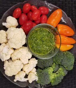 chimichurri and raw vegetables on a plate