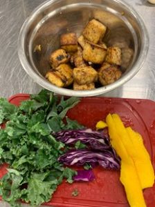 tofu bowl ingredients including kale, cabbage, peppers, and tofu