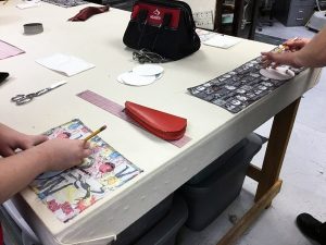 Image of students making earbud pouches