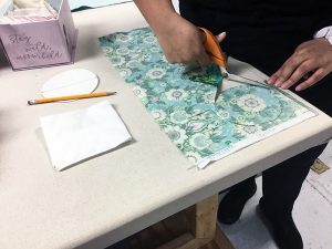 Image of students making earbud pouches