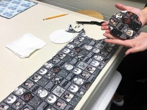 Image of students making earbud pouches